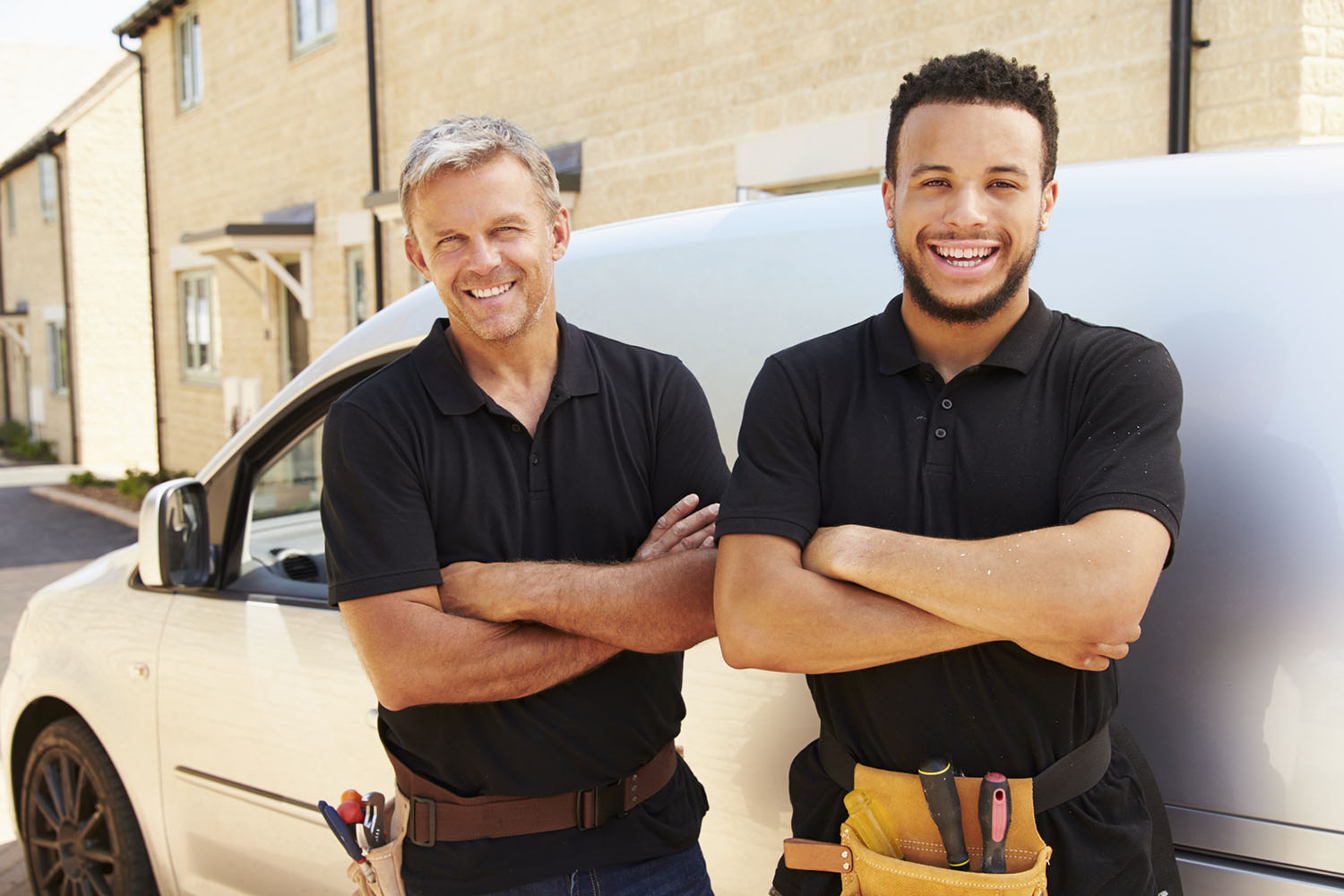 Two guys standing near a car